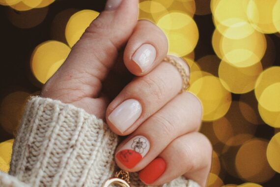 gold-colored hoop earring on human hand