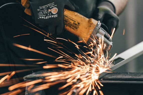 a man using a grinder on a piece of metal