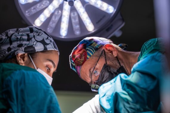 two surgeons performing surgery on a patient in a hospital